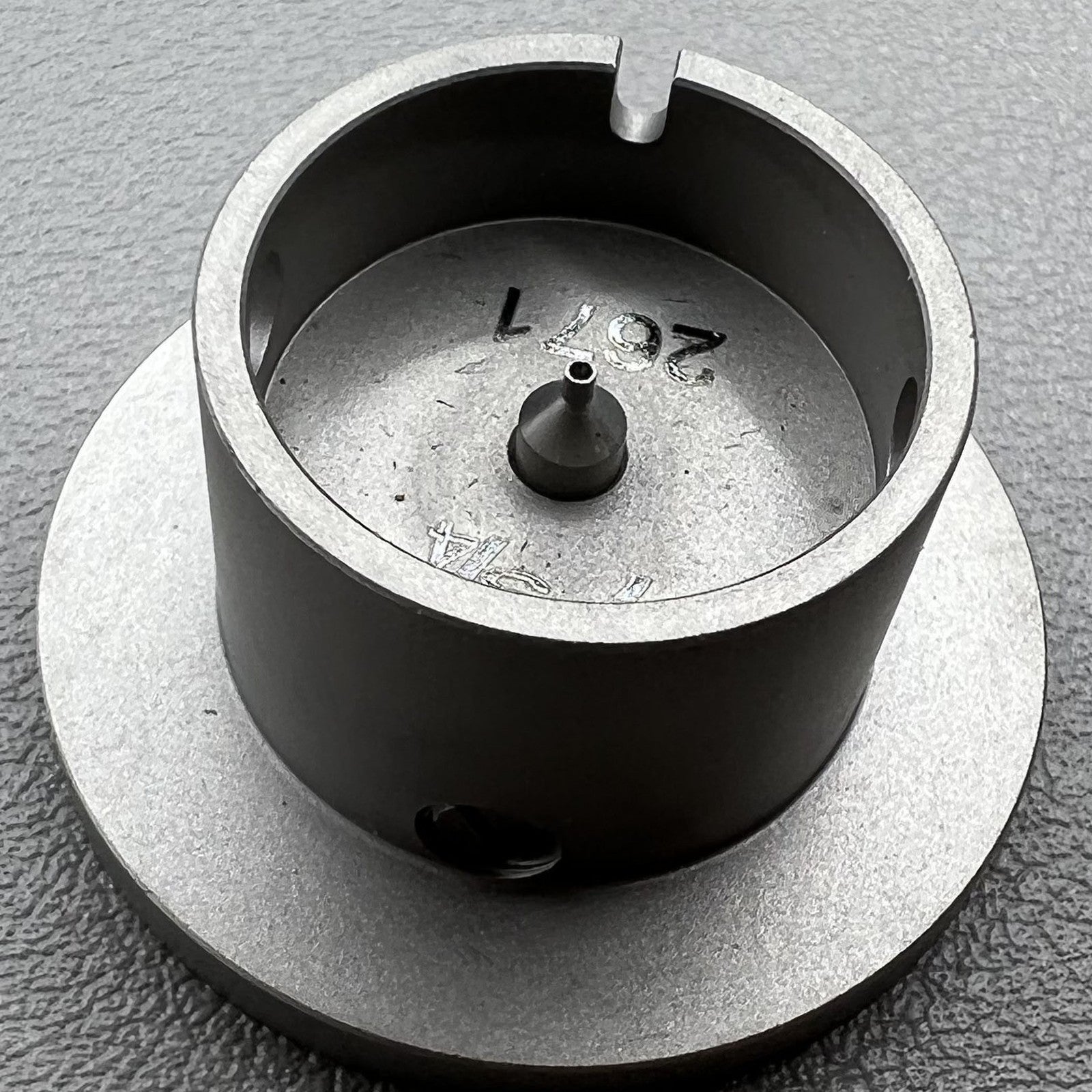 Size 7-3/4 ligne ETA 2671 movement holder with center screw for secure watch repair.