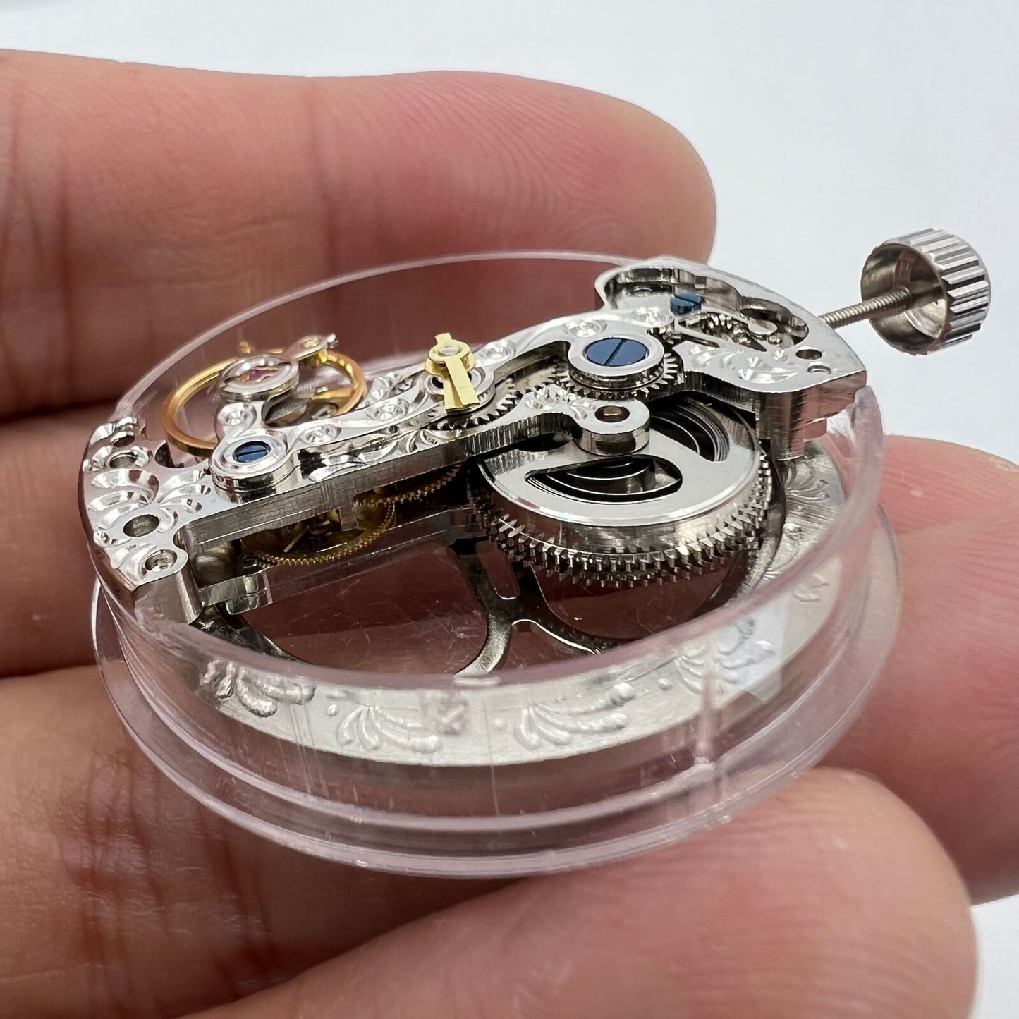 Silver long pendulum wheel watch accessory by Asian with detailed automatic mechanical movement design.