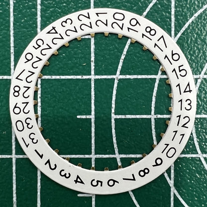 Wholesale lot of OM Font date wheels for ETA 2824 watches, showing date at 3 o?clock position.