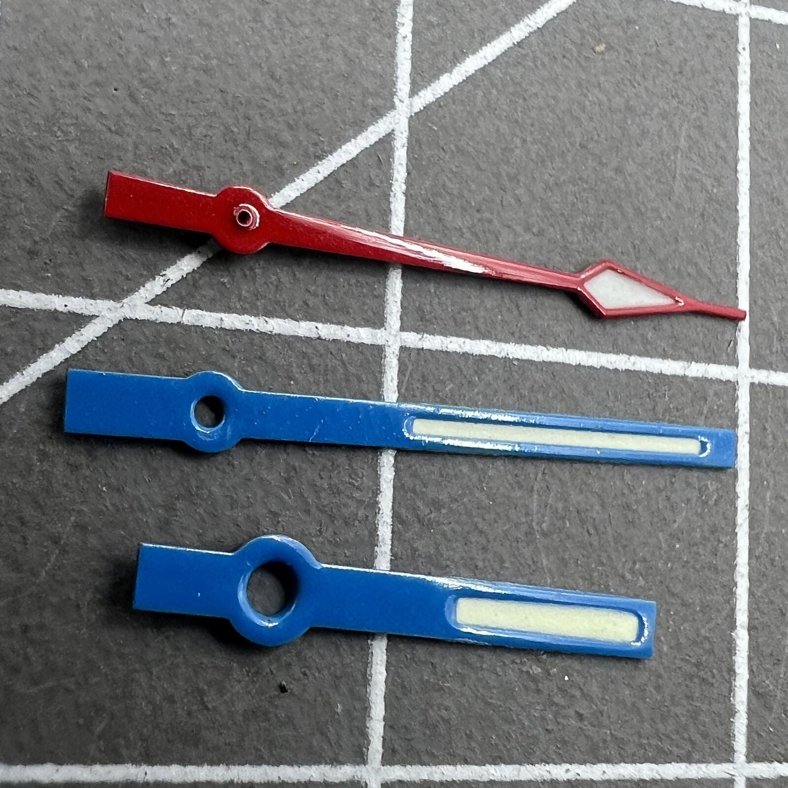 14mm watch hands with blue and red trim, green lume, for Ronda 515 quartz.