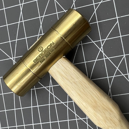 Swiss Made Bergeon 30416 brass hammer for precise watch accessory adjustments and repairs.