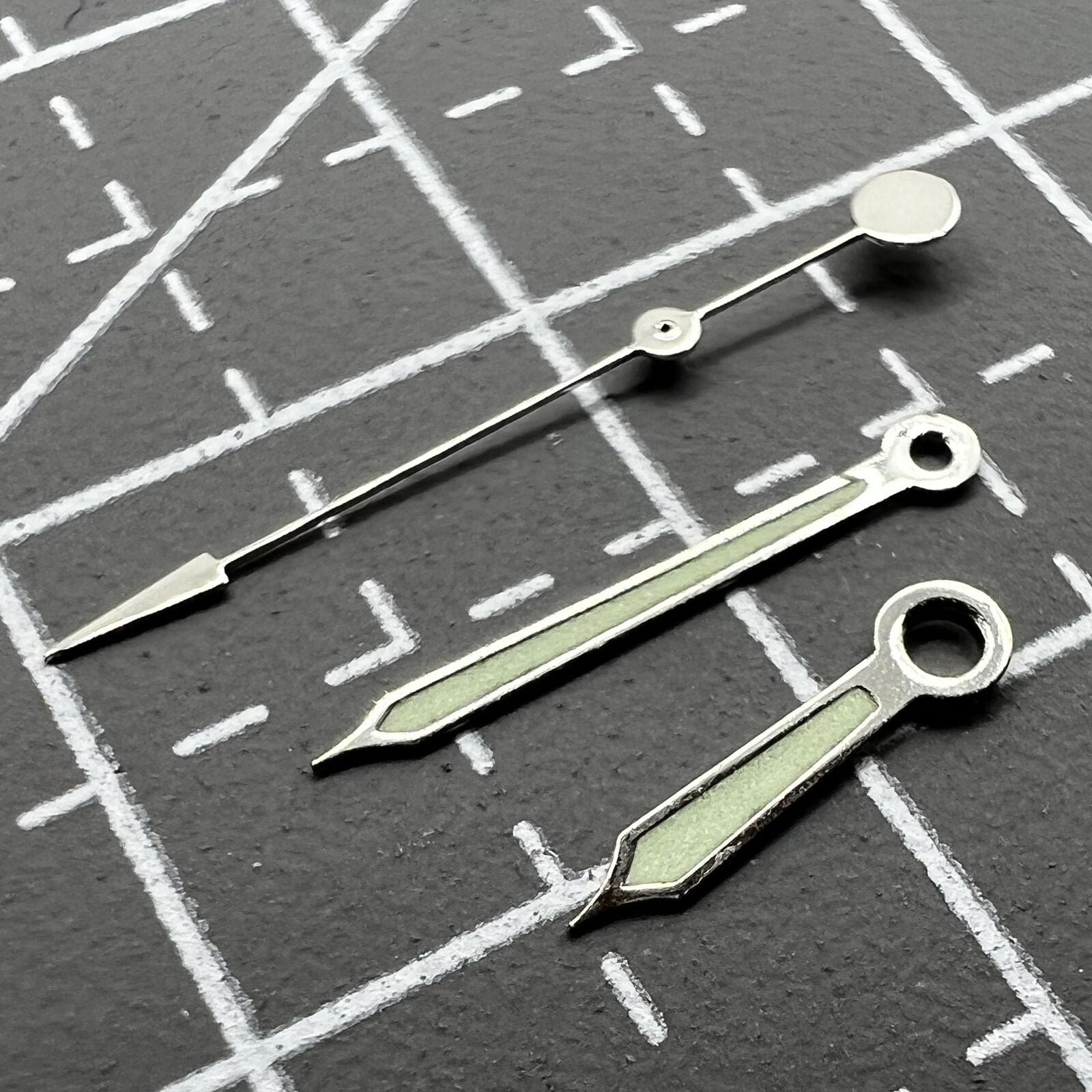 Green luminous watch hands with silver trim for Miyota 2035, 2115, 2105, 2305, 2315 movements.