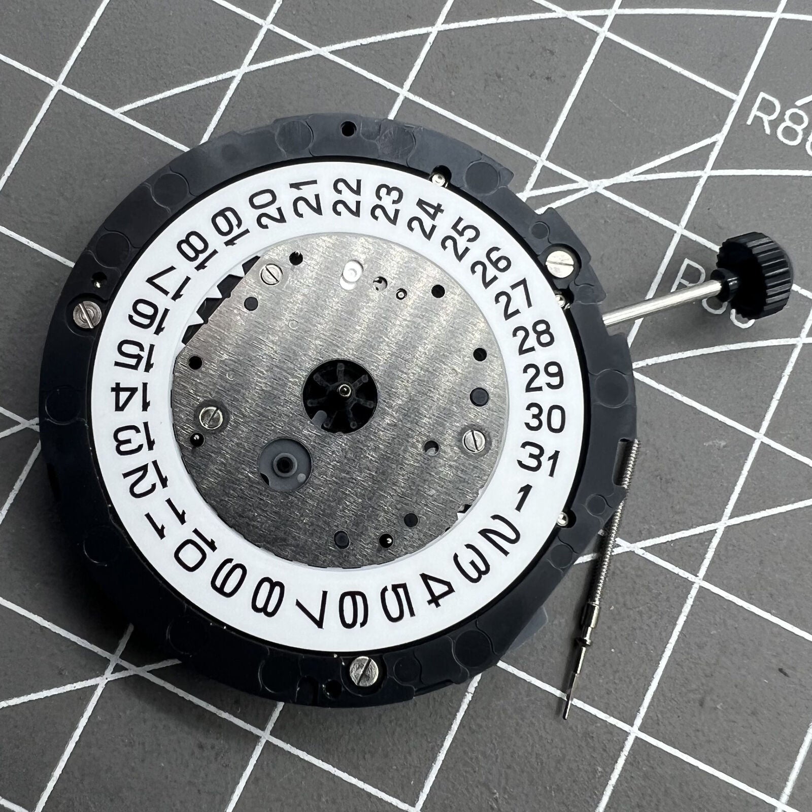 Miyota 6S10 quartz watch movement showing small seconds at 6, 9, 12 o'clock and date window at 3.