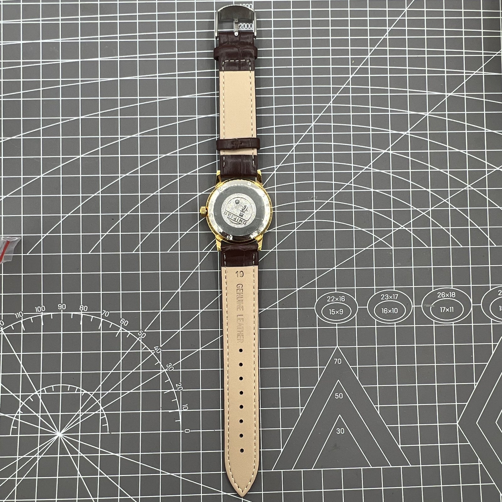 Beijing Double Rhomb manual watch, gold case with silver nail markers, classic vintage style accessory.