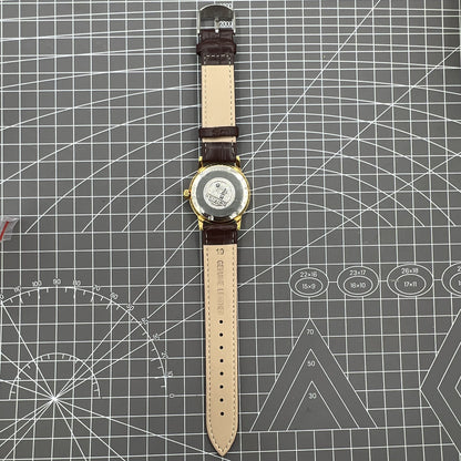 Beijing Double Rhomb manual watch, gold case with silver nail markers, classic vintage style accessory.