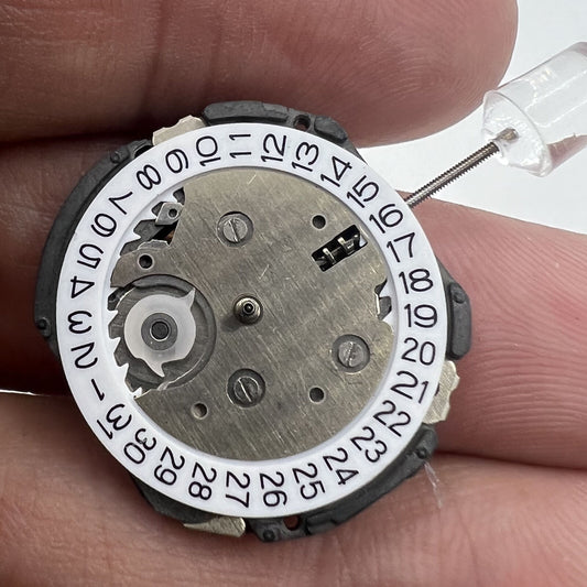 6EC1 quartz watch movement with date at 3, Japan-made repair part for precise timekeeping.