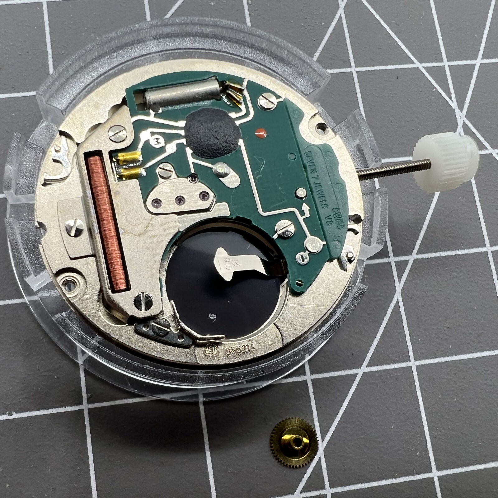 Close-up of Swiss Made ETA955.114 quartz watch movement with single calendar at 3 o?clock for repair.