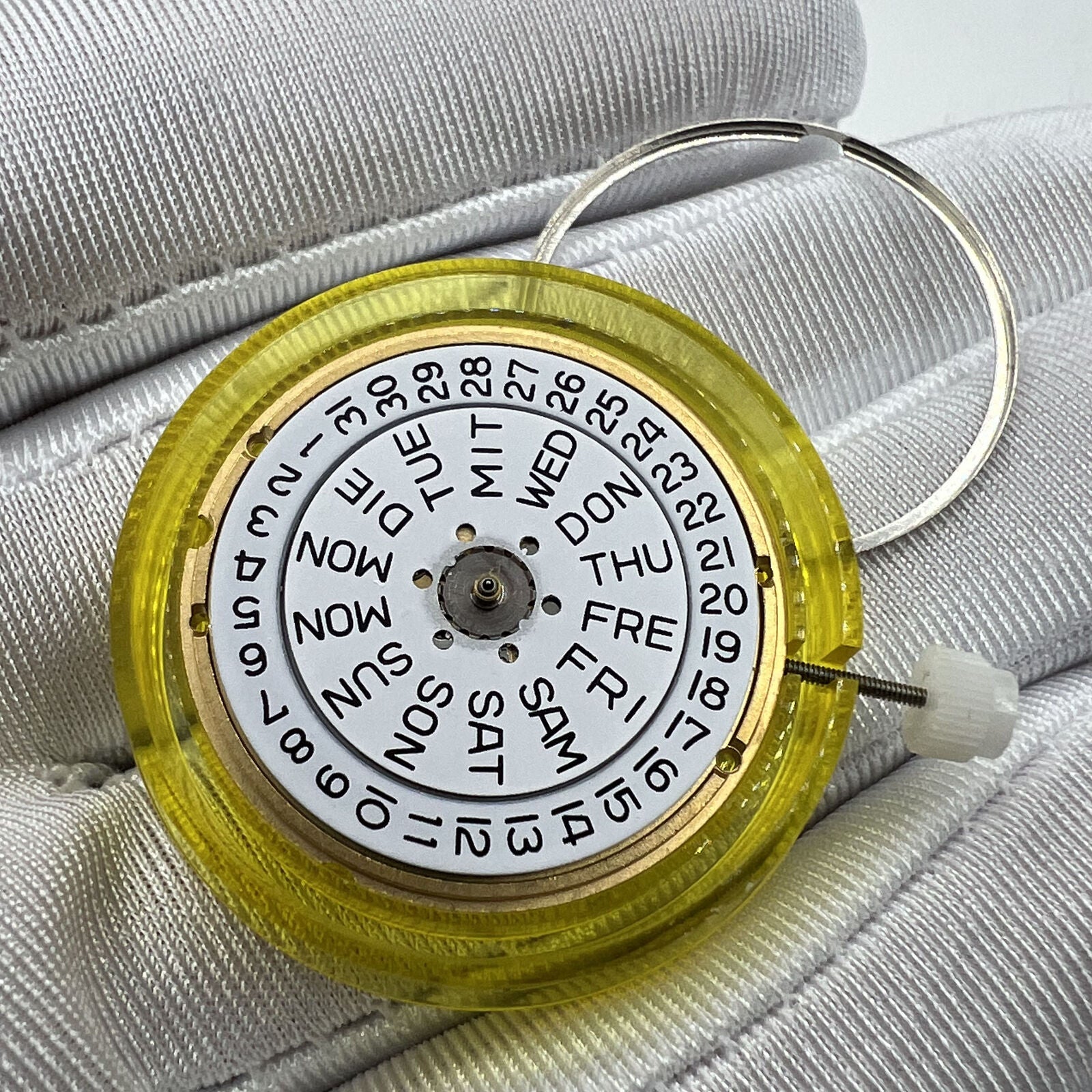 Swiss Made ETA 955.122 quartz watch movement with double calendar and three hands for precise timekeeping.