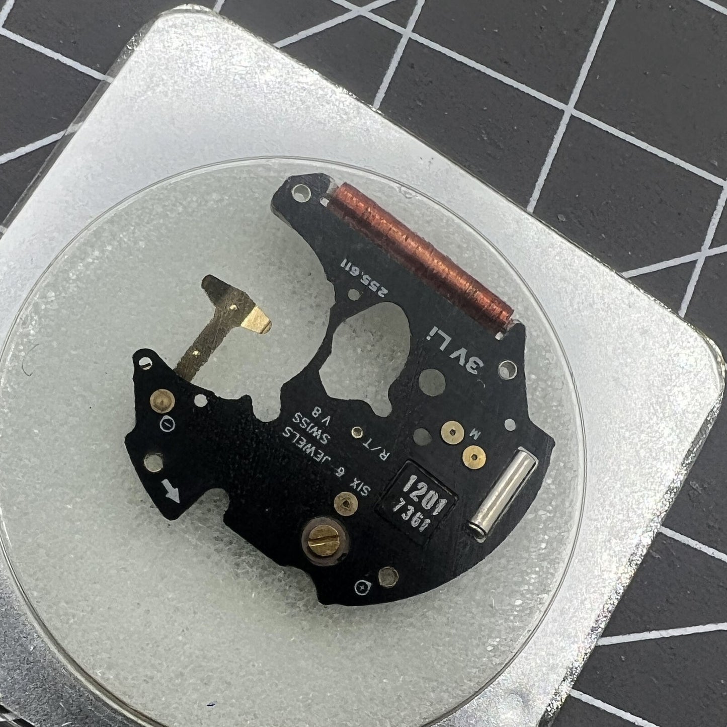 Disassembled ETA 255.111 watch movement circuit board for precise timekeeping replacement parts.