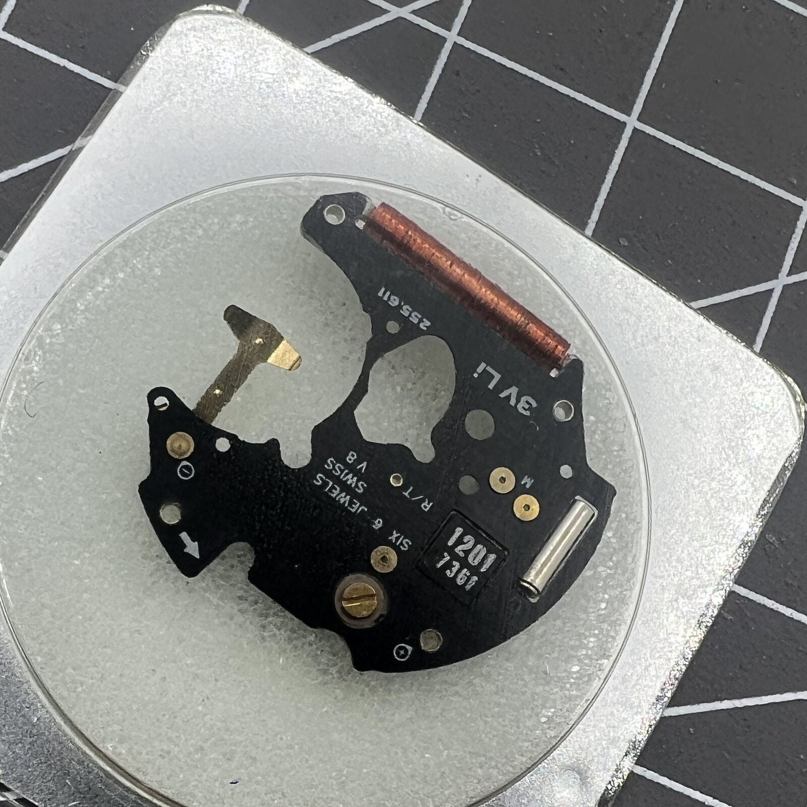 Disassembled ETA 255.111 watch movement circuit board for precise timekeeping replacement parts.