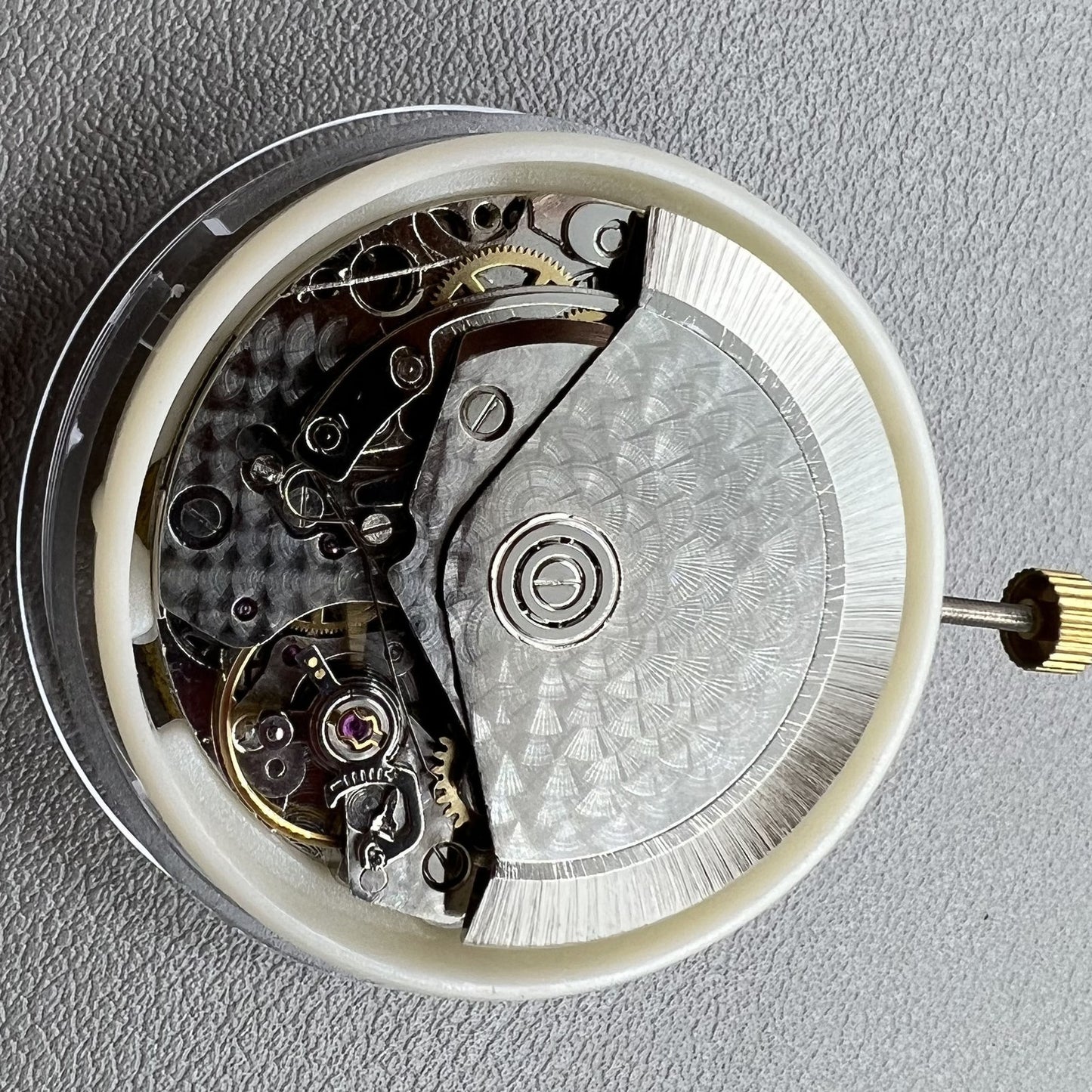 Dandong 7750 mechanical watch movement showing single calendar and small second subdials at 6, 9, and 12 o'clock positions for precise timekeeping