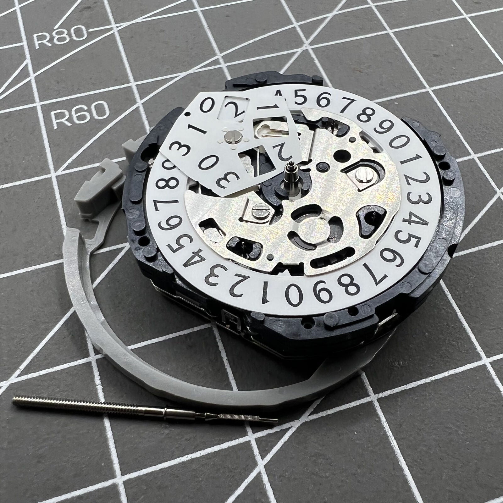 Epson YM04A quartz watch movement with big date display, precise timekeeping for watch repairs.