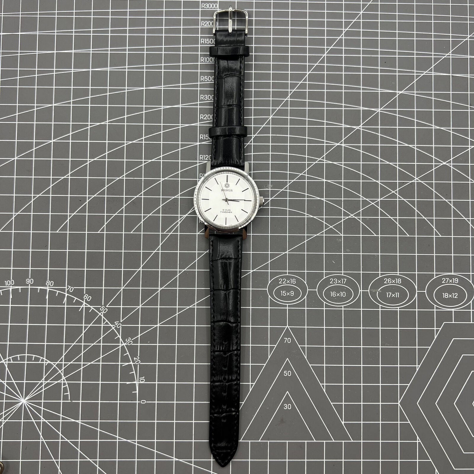 China Baihua 37mm manual mechanical watch with silver dial, 19 jewels, shock-resistant design for durability.