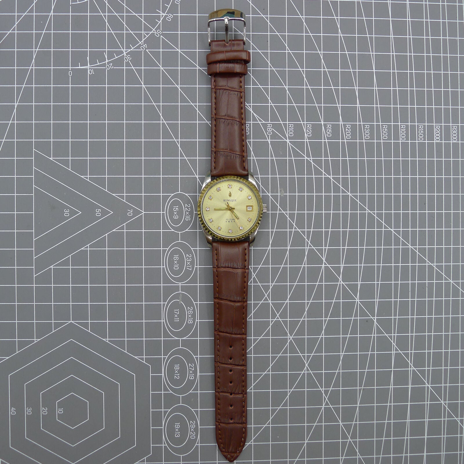 Dandong Peacock 37mm manual mechanical watch with golden dial, single calendar, 33 jewels, elegant design.