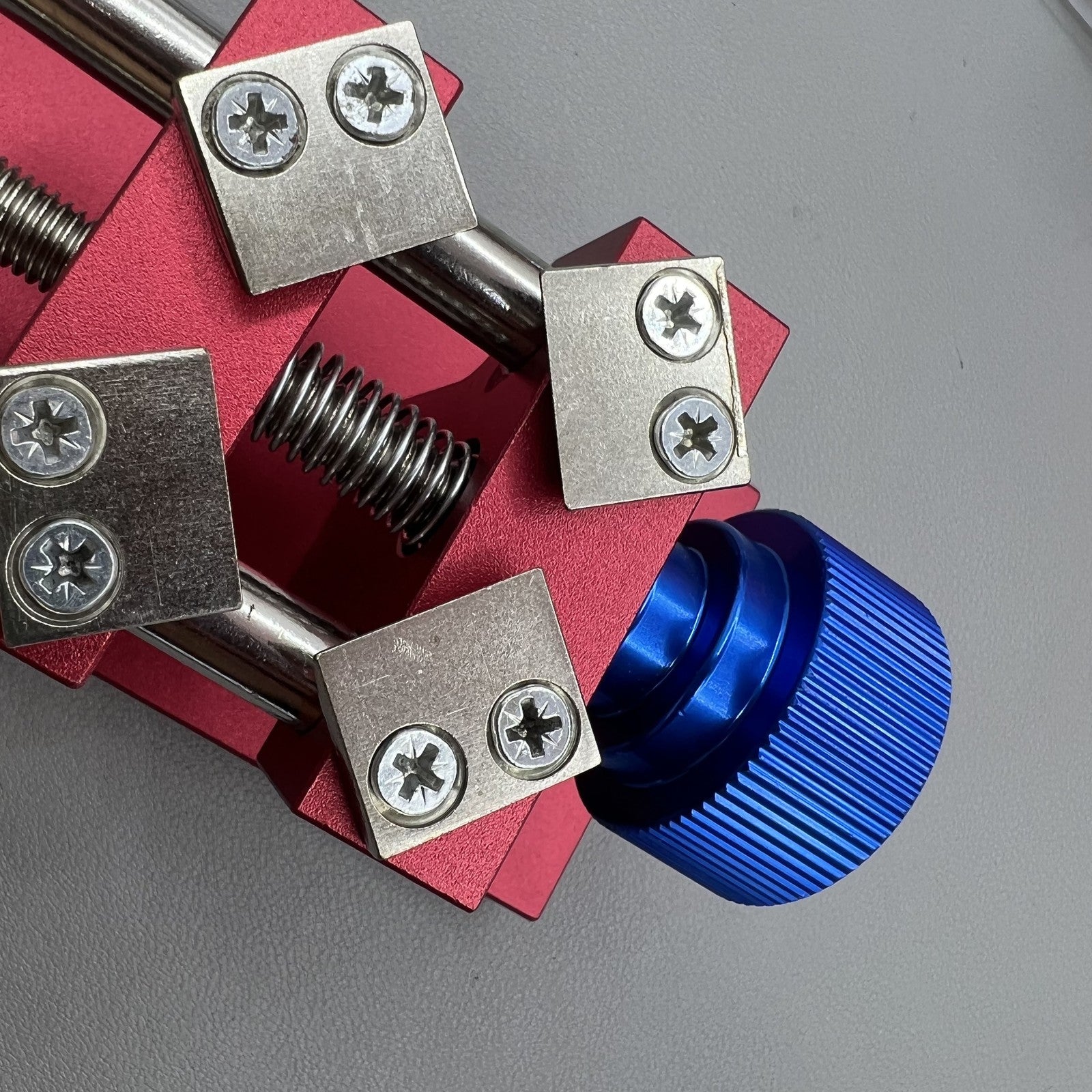 Professional watch bezel remover and case back opener tool for precise watch repair workbench.