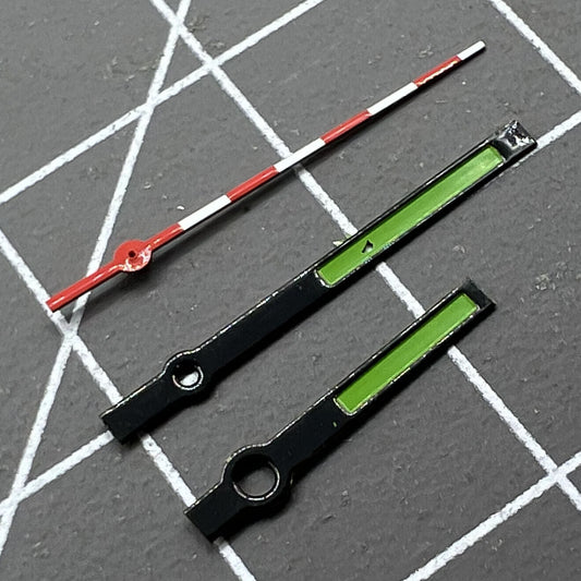 Black, red, and white trimmed green watch hands for Ronda 515 quartz, perfect for precise timekeeping.