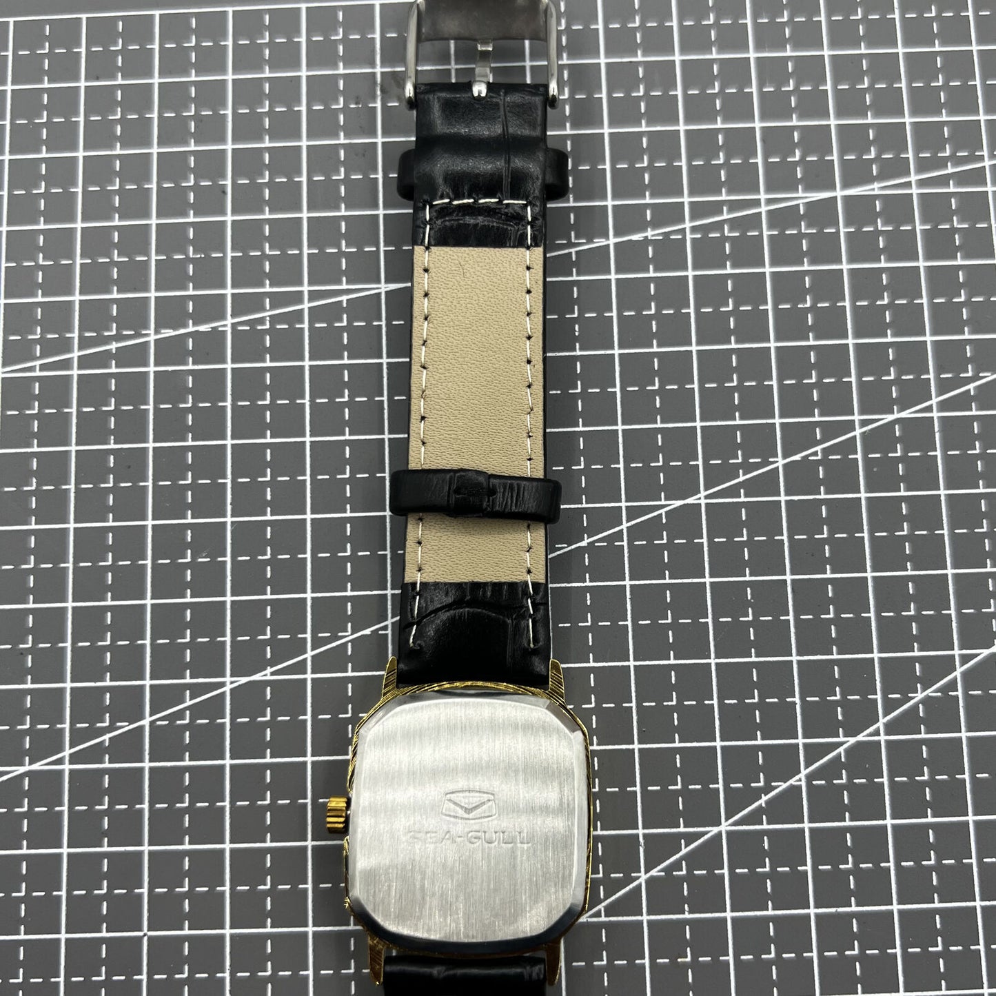 28mm Tianjin Seagull watch with octagonal gold case, golden dial, and manual mechanical movement for elegant wear.