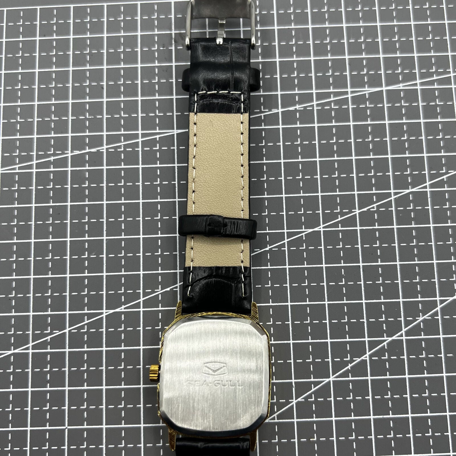 28mm Tianjin Seagull watch with octagonal gold case, golden dial, and manual mechanical movement for elegant wear.