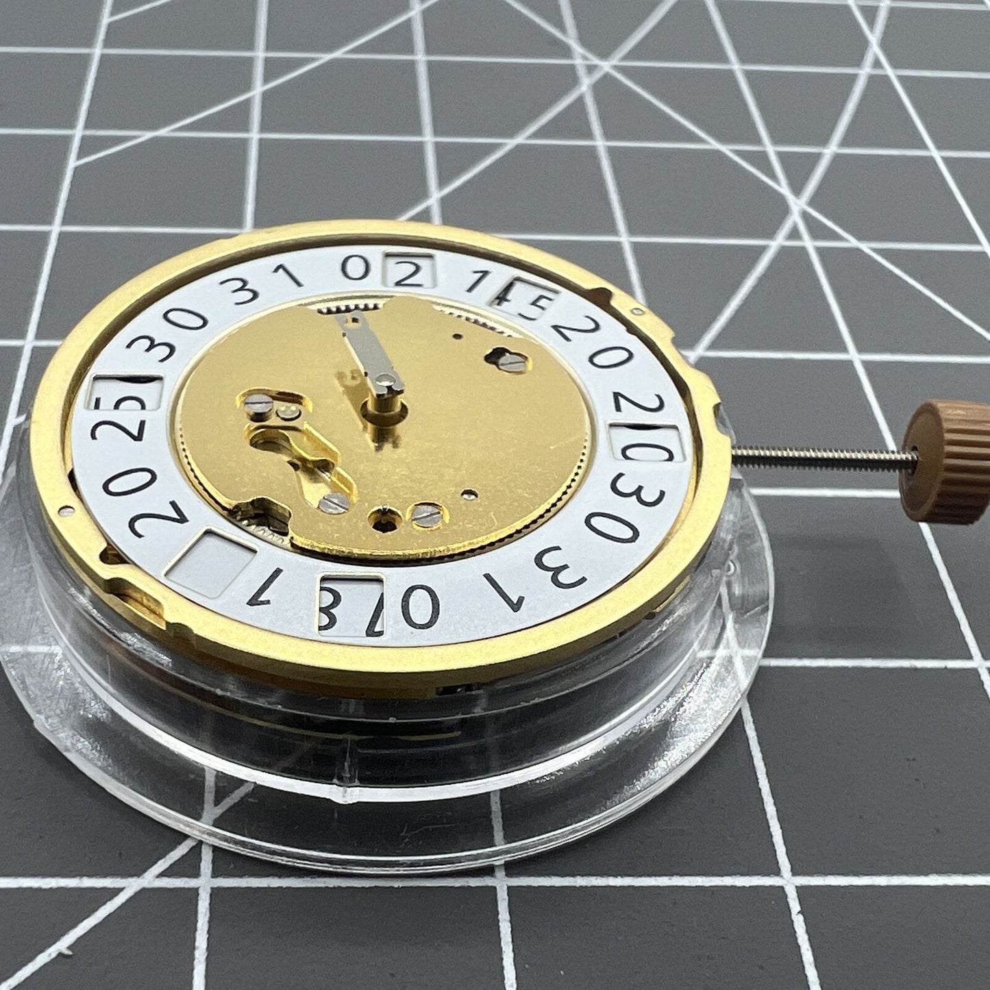 Golden Swiss Made Ronda 6004B quartz watch movement with date display at 12 o'clock, precise timekeeping.
