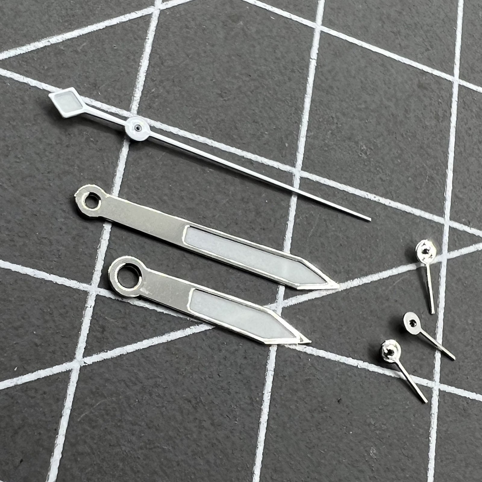 14.5mm silver and white trim green luminous watch hands for VD53 VD54 VD57 movement, glowing in low light.