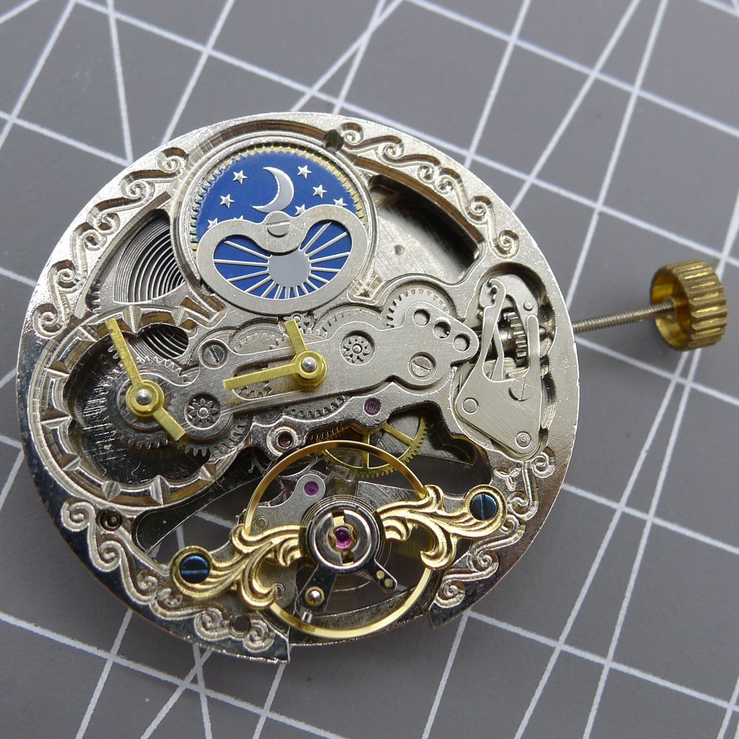 Automatic mechanical watch with silver 3 hands, hollow moon phase display at 12 o'clock.