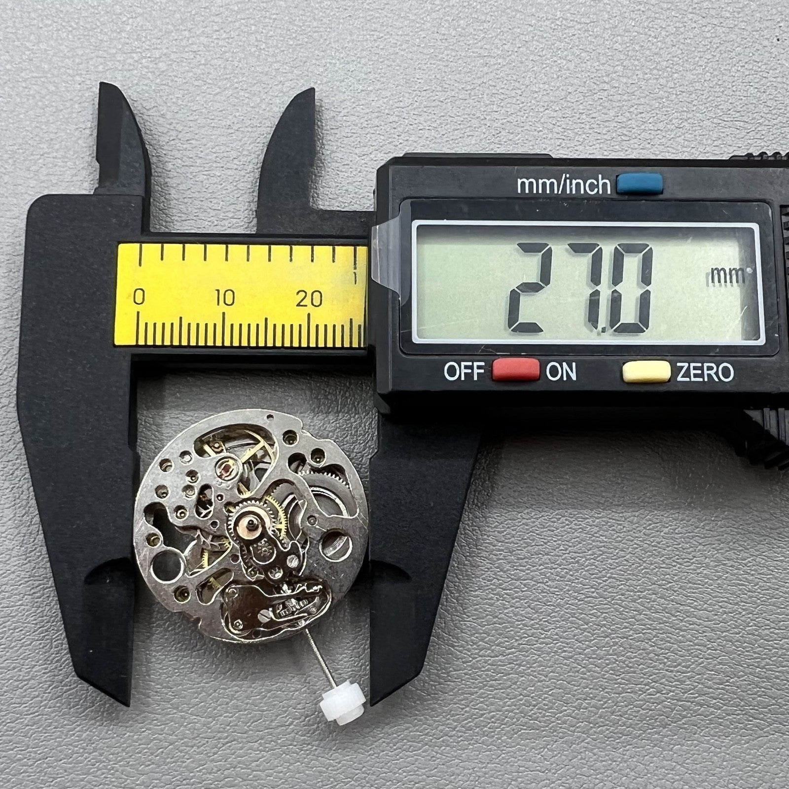 7120 Hollow silver automatic watch movement with visible intricate gears, highlighting precise craftsmanship.