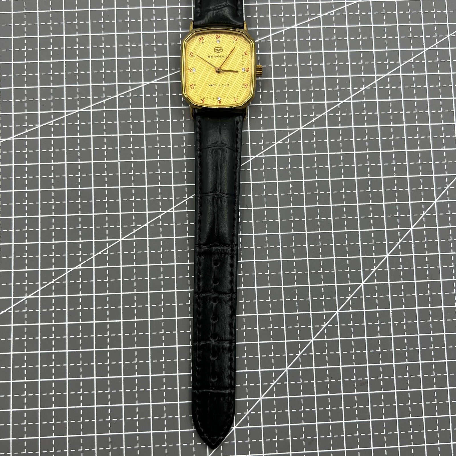 28mm Tianjin Seagull watch with octagonal gold case and golden dial, manual mechanical movement, elegant timepiece.