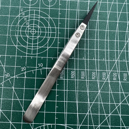 Stainless steel tweezers with carbon fiber tip, ideal for precise watch repair.