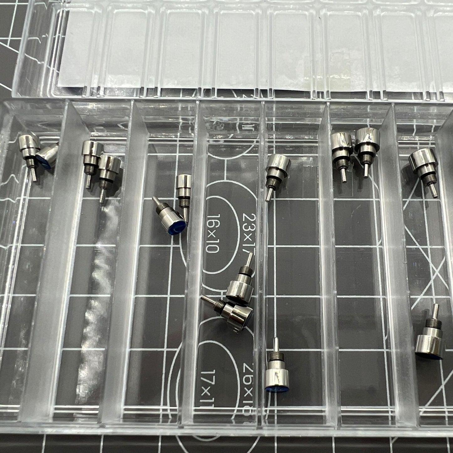 Set of 14 stainless steel watch pushers in 7 sizes, classic silver design for precise watch repair tasks.