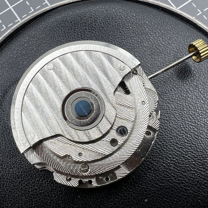 Multifunctional automatic watch featuring mechanical movement and moon phase at 12 o'clock.