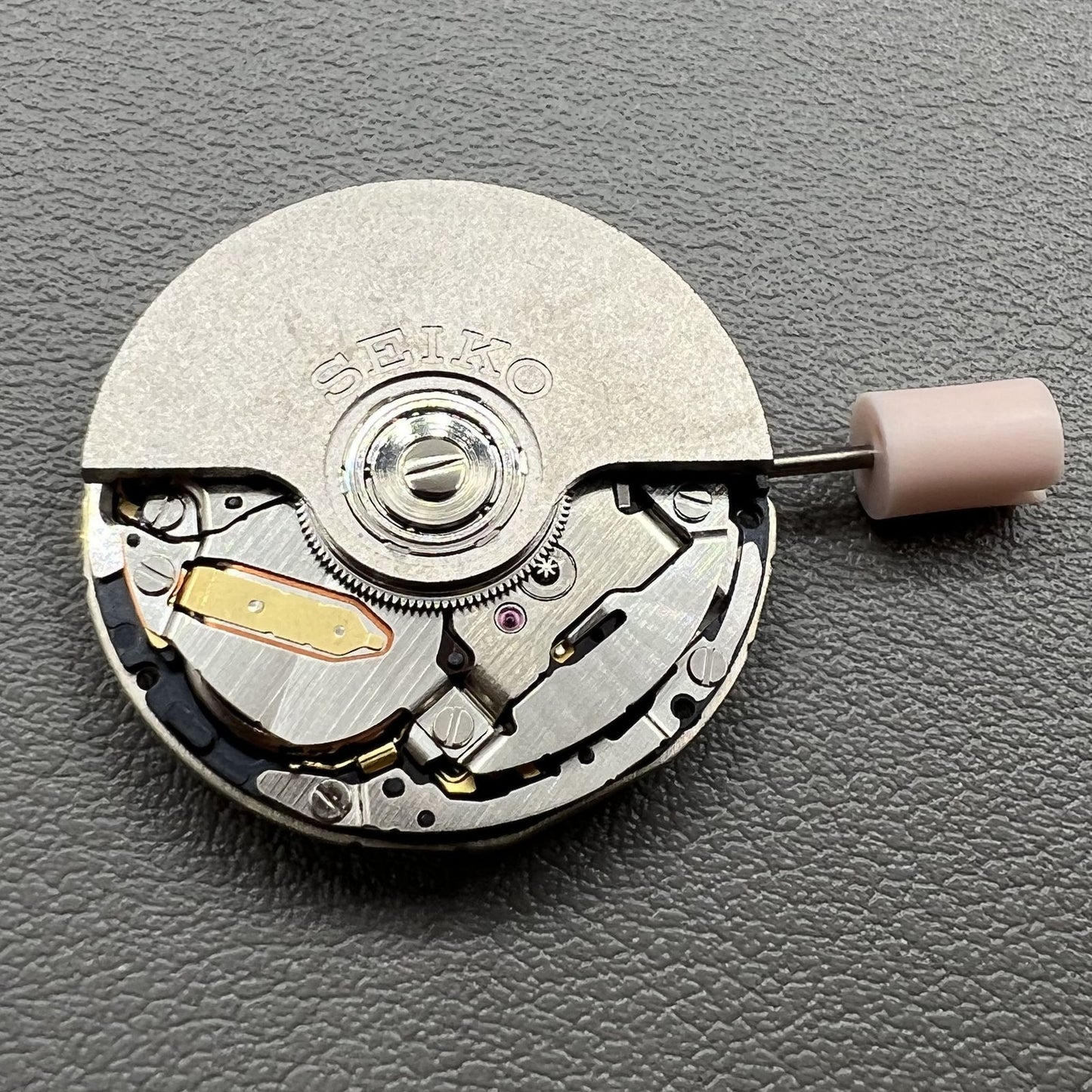 Seiko 5J32A quartz watch movement with black disk and single calendar, precise timekeeping component.