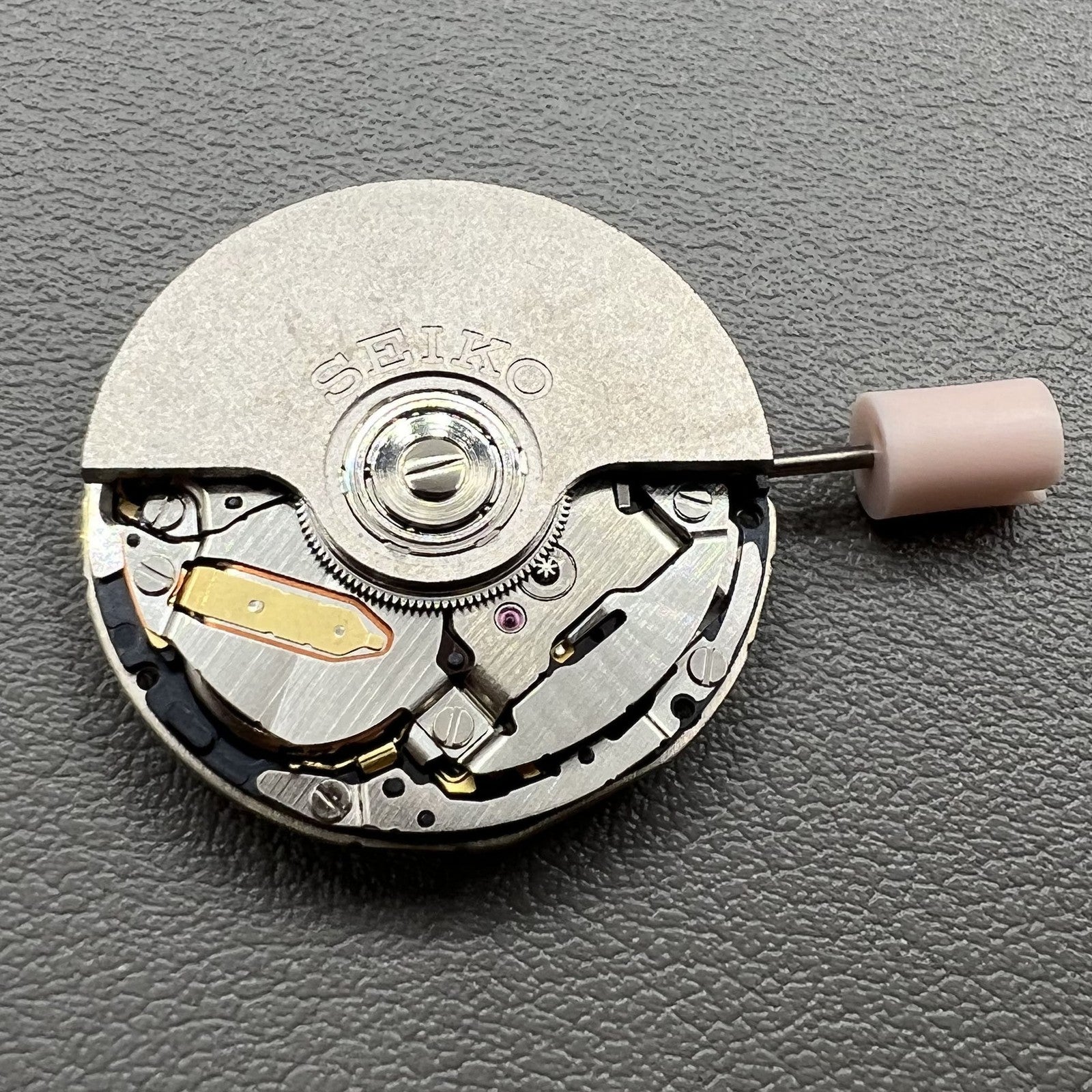 Seiko 5J32A quartz watch movement with black disk and single calendar, precise timekeeping component.