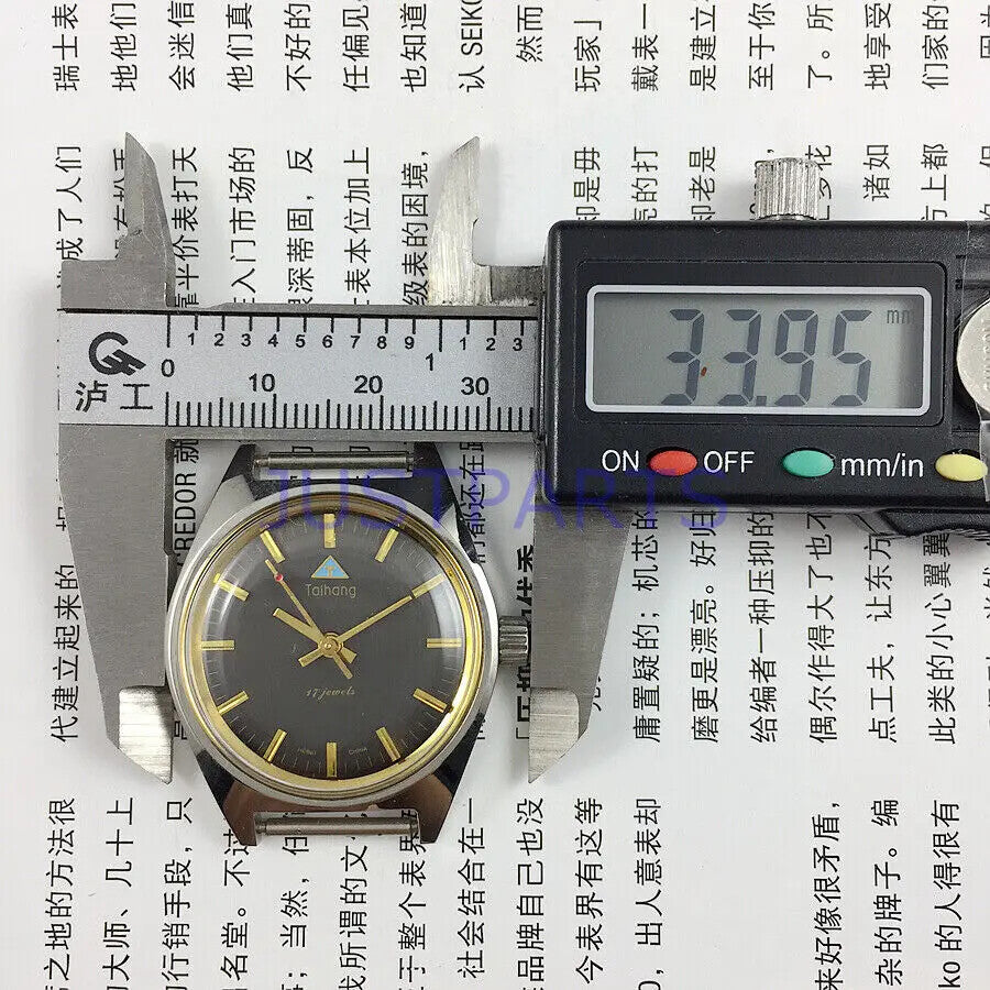 Taihang 32mm manual mechanical watch with black strap, golden nails, and black dial for classic style.