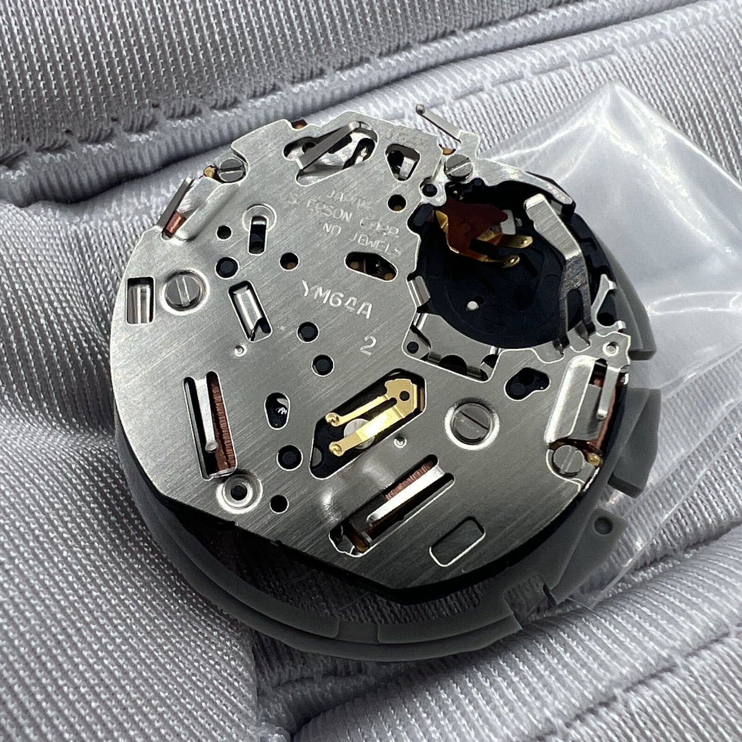 Hattori Epson TMI YM64A quartz watch movement, Japan made, ensuring precise timekeeping for watch repairs.