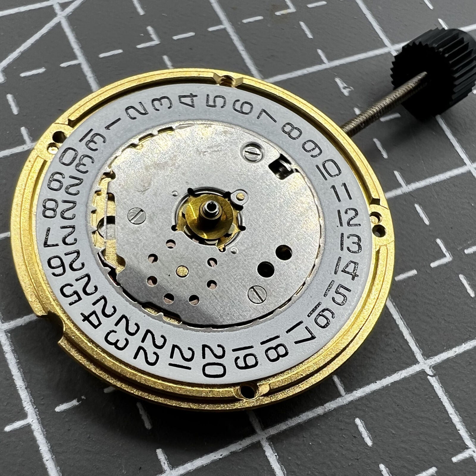 ETA F04.111 quartz watch movement with three hands and date function, Swiss precision craftsmanship.