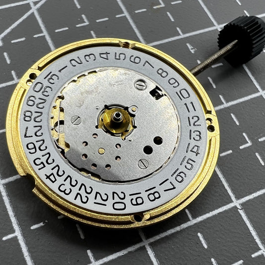 ETA F04.111 quartz watch movement with three hands and date function, Swiss precision craftsmanship.