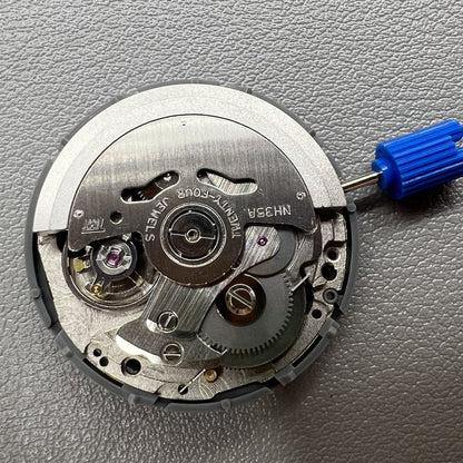 Japan NH35 automatic chronograph watch dial in black with date window and crown at 3 o?clock.