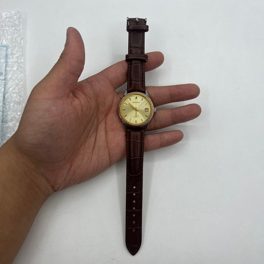Shanghai 37mm manual watch with golden dial, nail markers, round case, 17 jewel mechanical movement.