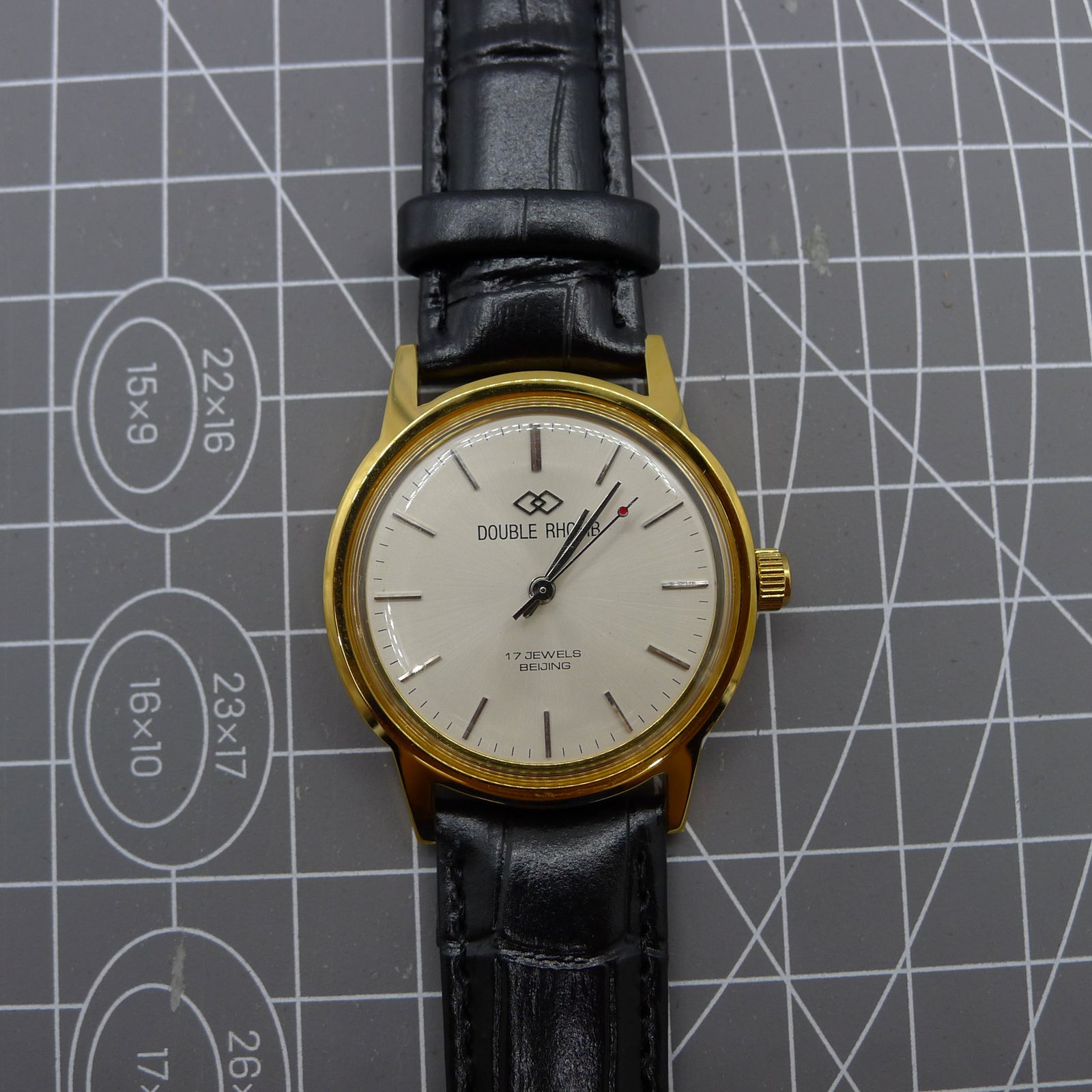 Beijing Double Rhomb mechanical watch with golden case and silver hour markers, elegant classic style.