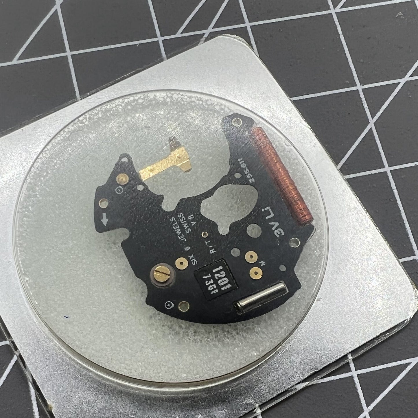 ETA 255.111 watch movement circuit board by ETA, disassembled for precise timekeeping repair.