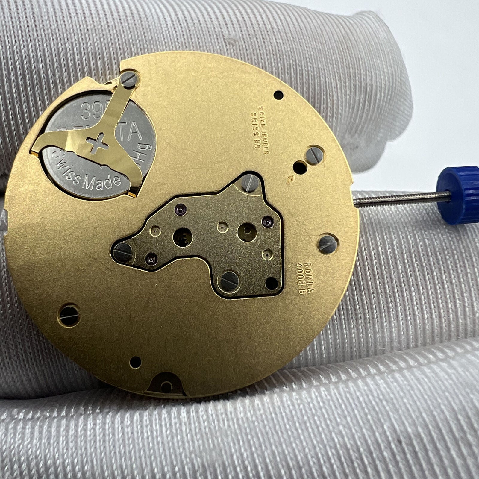 Swiss Ronda 4003B quartz watch movement with date window at 12, precision Swiss-made accessory component.