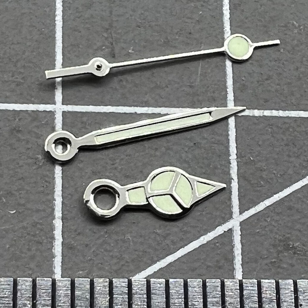 Silver trim green lume watch hands set for Miyota 2035 movement, enhancing visibility and style.