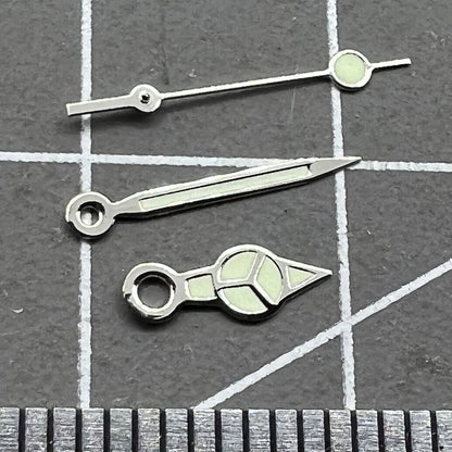 Silver trim green lume watch hands set for Miyota 2035 movement, enhancing visibility and style.