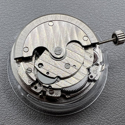 Tianjin ST17 T17 hand-wound watch movement with two hands and power reserve indicator at 10 o'clock.
