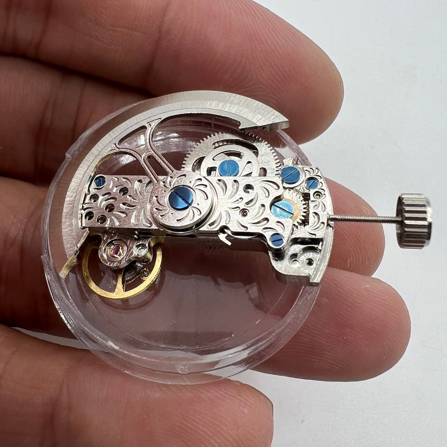 Silver long pendulum wheel watch accessory by Asian with visible automatic mechanical movement details for precision timing