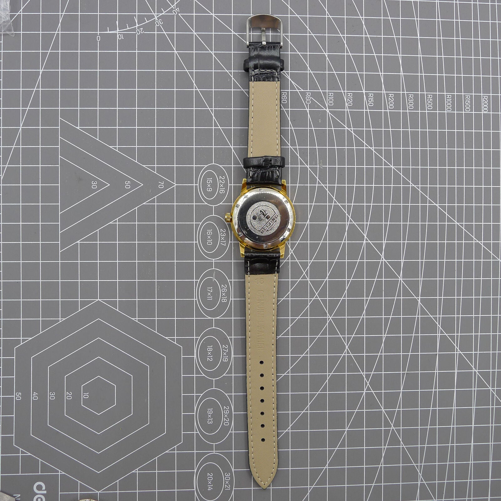 Beijing Double Rhomb watch with golden case, silver nail markers, manual mechanical movement, classic style timepiece.