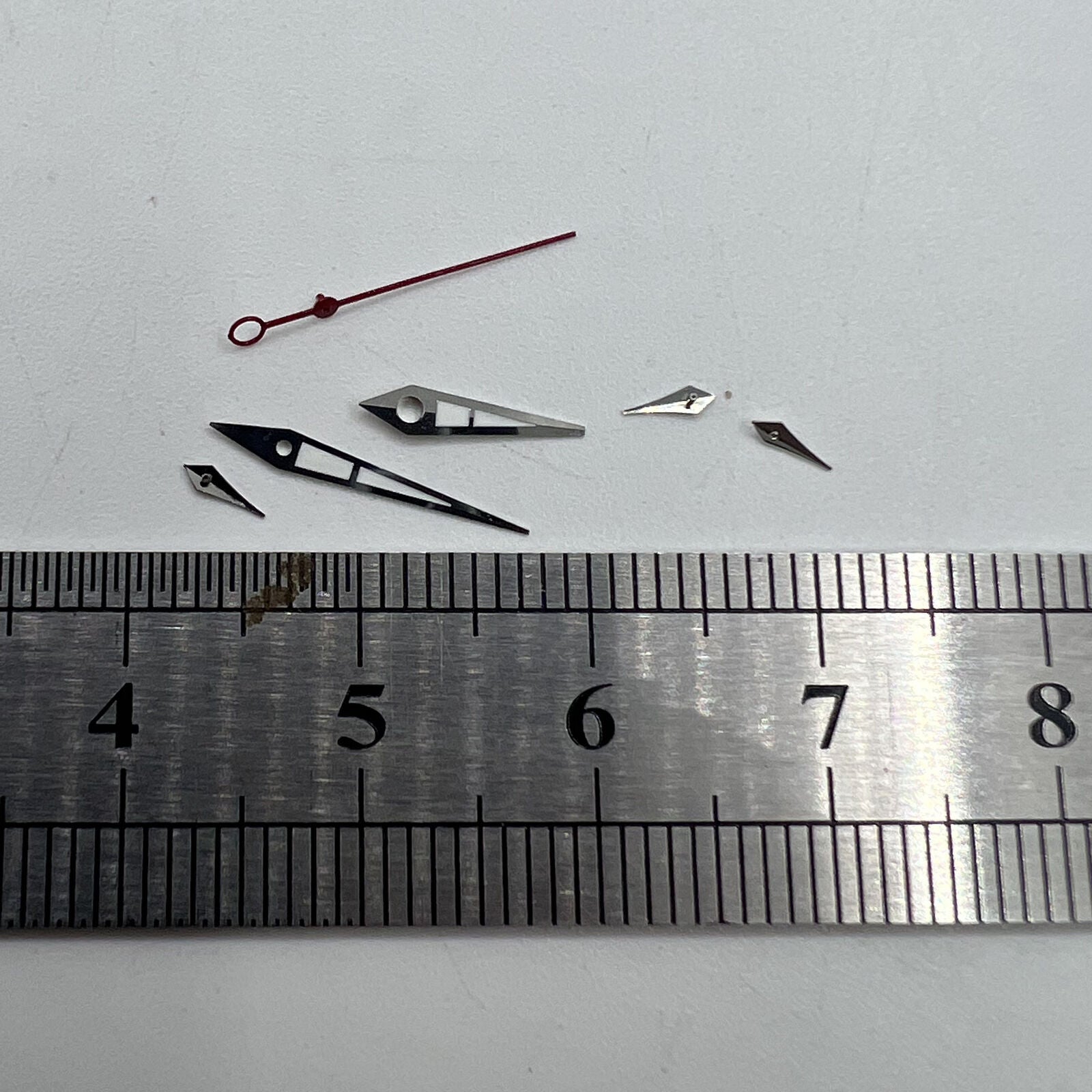 Green luminous watch hands with silver trim for ISA 9238 quartz movement, ensuring precision and durability.