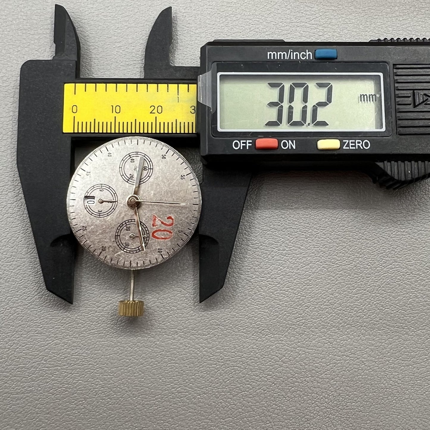 Chronograph watch accessory with ETA 7750 movement, white dial, calendar at 6, second hand at 9, precision timepiece.