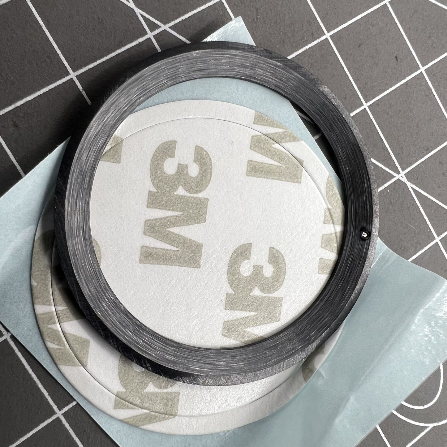 38mm ceramic watch bezel with black slope, silver font, and blue luminous accents for watch accessories.