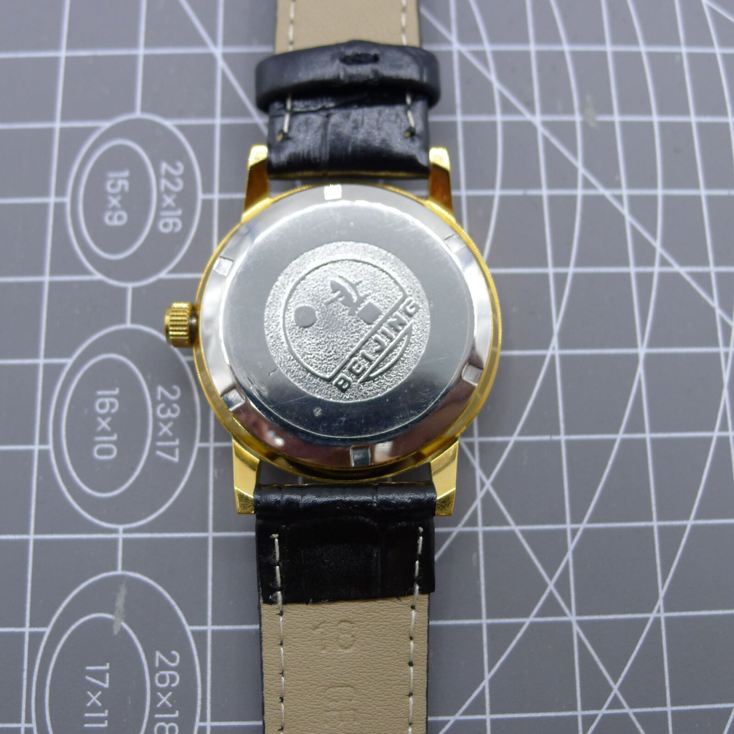 Beijing Double Rhomb watch with golden case, silver nail markers, manual movement for timeless elegance.